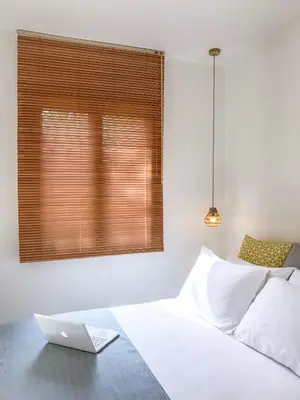 a bedroom with a white bed with a laptop on it at Villa Pefki in Chania Town