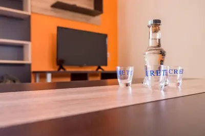 a bottle and two glasses sitting on a table at Mamis Studio in Kissamos