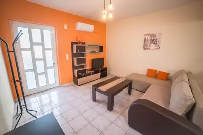a living room with a couch and a table at Mamis Studio in Kissamos