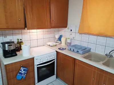 a kitchen with a sink and a stove top oven at Mamis Studio in Kissamos