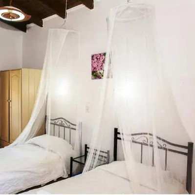 two beds with mosquito nets in a bedroom at Stavros Villas&Apartments in Gerani Chanion
