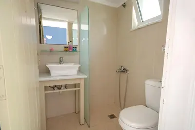 a bathroom with a toilet and a sink and a mirror at Stavros Villas&Apartments in Gerani Chanion