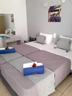 two beds sitting next to each other in a room at Stavros Villas&Apartments in Gerani Chanion