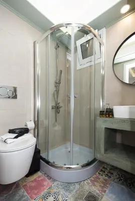 a bathroom with a shower with a toilet and a sink at NK Apartments in Falasarna