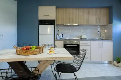 a kitchen with a table with a basket of fruit on it at NK Apartments in Falasarna