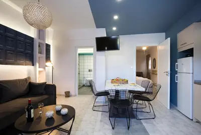 a living room with a couch and a table at NK Apartments in Falasarna
