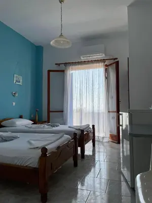 a room with two beds and a window at Panorama Rooms in Agia Roumeli