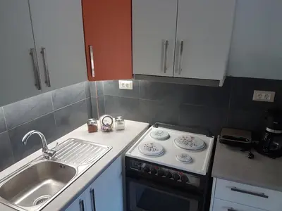 a kitchen with a stove top oven next to a sink at Elia Guesthouse - Kissamos in Kissamos