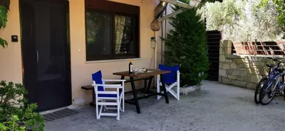 a table and chairs sitting outside of a house at Elia Guesthouse - Kissamos in Kissamos