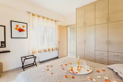 a bedroom with a bed with a plate of food on it at Villa Oasis in Galatás