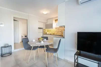 a kitchen and dining room with a table and chairs at Villa Oasis in Galatás