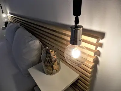 a lamp and a vase on a table next to a bed at Feels like home in Chania Town