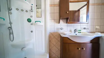 a bathroom with a sink and a shower at Ilios Village in Stalos