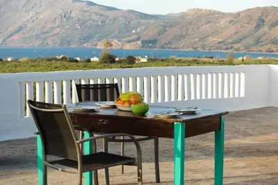 a wooden table with a bowl of fruit on it at Villa Stefania - with Sea View Terrace in Drapaniás