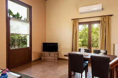 a dining room with a table and a television at Filio House in Stalos