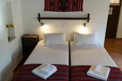 a bed with two white pillows on top of it at Arhondiko in Sougia