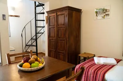 a room with a table with a bowl of fruit on it at Arhondiko in Sougia