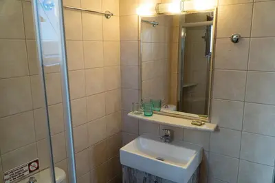 a bathroom with a sink and a mirror at Arhondiko in Sougia
