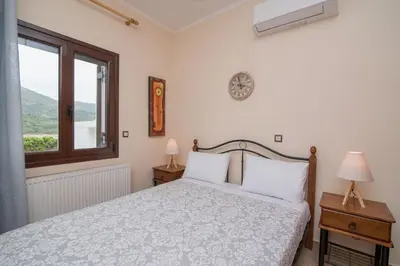 a bedroom with a bed and a window at Marika Traditional Home in Élos