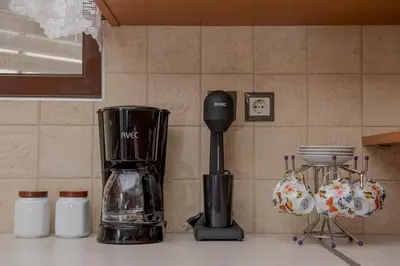 a kitchen counter with a blender on a counter top at Marika Traditional Home in Élos