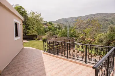 a balcony of a house with a view of the mountains at Marika Traditional Home in Élos