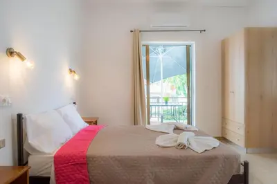 a bedroom with a bed with towels on it at Stellar Apartments I in Plataniás