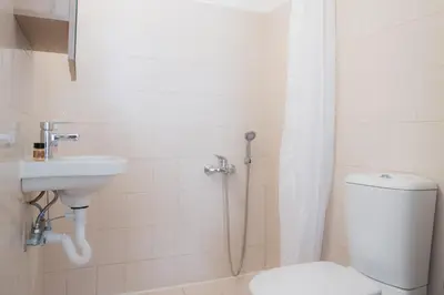 a bathroom with a shower and a toilet and a sink at Stellar Apartments I in Plataniás