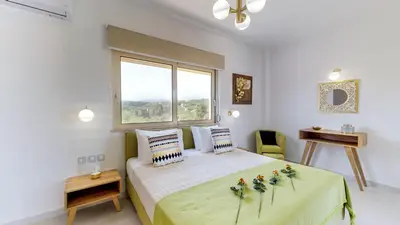 a bedroom with a large bed with flowers on it at Liberty & Freedom Luxury Villa-heated pool in Plataniás