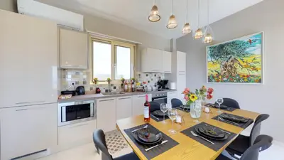 a kitchen with a table with chairs and a dining room at Liberty & Freedom Luxury Villa-heated pool in Plataniás