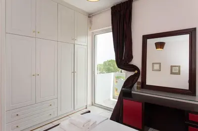 a room with a mirror and a window at Thalassa Old Town Apartment in Chania Town