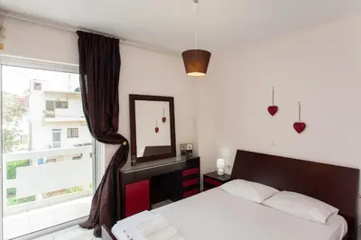 a bedroom with a bed and a window at Thalassa Old Town Apartment in Chania Town