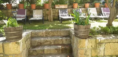 a group of chairs and chairs in a yard at Cactus in Nopíyia