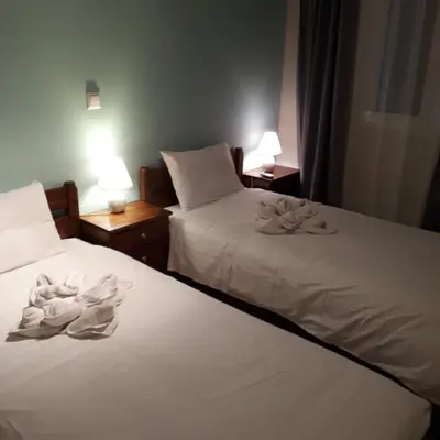 two beds in a room with towels on them at Cactus in Nopíyia