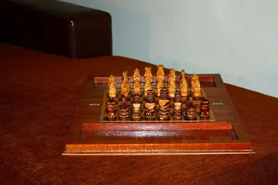 a wooden chess board with aedesbestosbestos at Cactus in Nopíyia