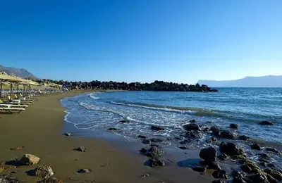 a beach with a bunch of rocks in the water at Molos Bay Hotel in Kissamos