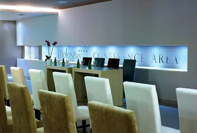 a meeting room with a table and chairs at Molos Bay Hotel in Kissamos