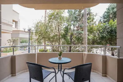 a patio with a table and chairs on a balcony at Molos Bay Hotel in Kissamos