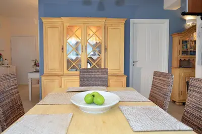 a dining room table with a bowl of apples on it at Villa Europa - Western Crete - Chania in Darmarochori