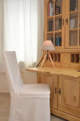 a white chair sitting next to a desk with a lamp at Villa Europa - Western Crete - Chania in Darmarochori