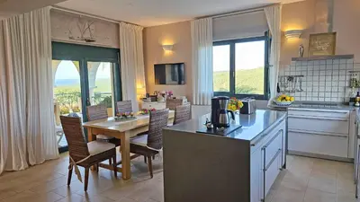 a kitchen and dining room with a table and chairs at Villa Europa - Western Crete - Chania in Darmarochori