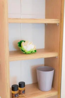 a wooden shelf with a flower and two jars at Stellar Apartments II in Plataniás