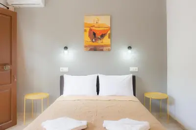 a bedroom with a bed with two white pillows at Stellar Apartments II in Plataniás