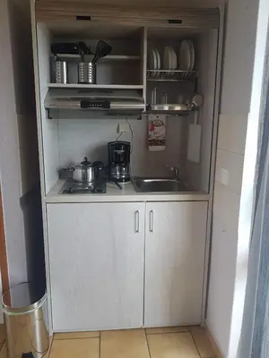 a small kitchen with a sink and a counter top at Piccolo Paradiso Apartments in Kato Daratso