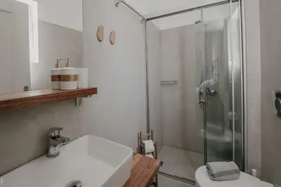 a bathroom with a shower and a sink and a toilet at Tellus City in Chania Town