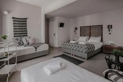 a living room with two beds and a couch at Tellus City in Chania Town