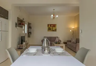 a kitchen with a table with a tea kettle on it at Maria's Garden in Galatás