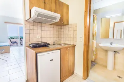 a small kitchen with a sink and a microwave at Alonia Hotel Apartments in Kolymvari