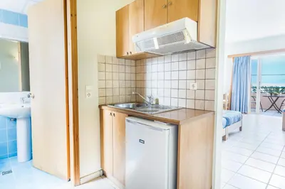 a small kitchen with a sink and a microwave at Alonia Hotel Apartments in Kolymvari