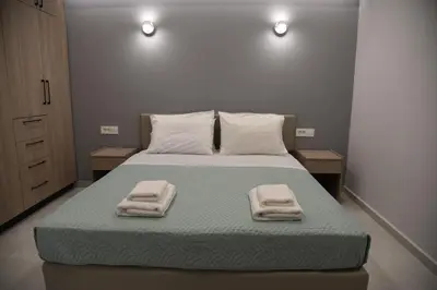 a bedroom with a bed with two towels on it at Pirgos Deluxe Apartment - Private Parking in Kissamos