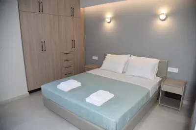 a bedroom with a bed with two towels on it at Pirgos Deluxe Apartment - Private Parking in Kissamos